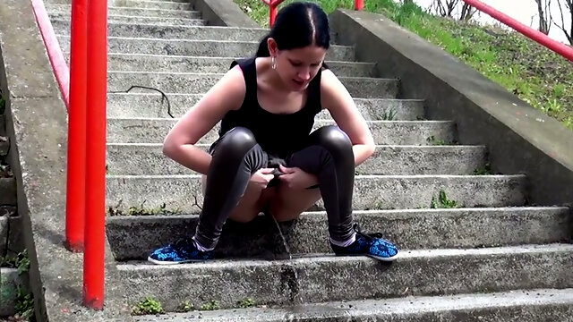 Raven haired filthy girl finds pissing on stairs very captivating