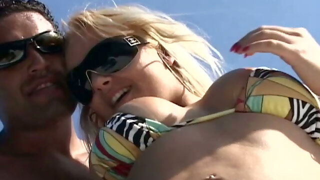 Horny blondie in sunglasses strips on the yacht for winning a stiff dick