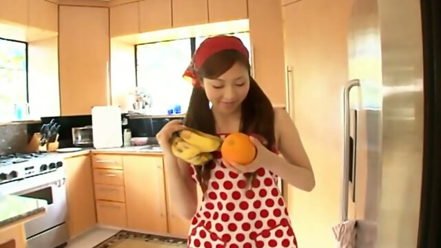 Young Japanese house wife Natsuko Tatsumi makes a fruit salad