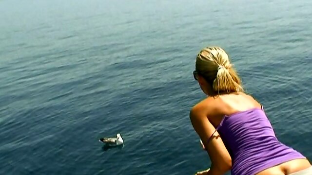 Obedient housewife Sandy takes a sun bath on the boat topless