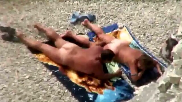Kinky mature sunbathing wife gets her pussy fingered a bit on the beach