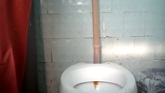 Blonde stranger milf in orange dress pisses in the toilet room