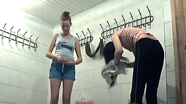 Cute and slender white teen babes in the shower room caught on voyeur video