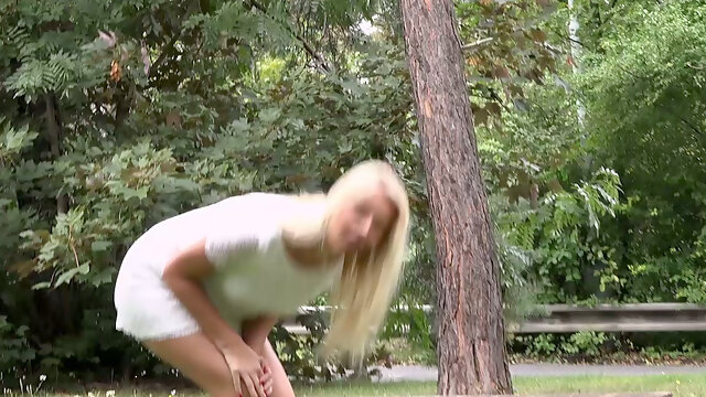 Hot blonde sexy babe in white dress pisses in the park