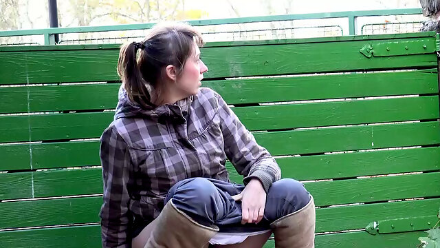 Cute brunette country girl in plaid shirt pees behind the fence