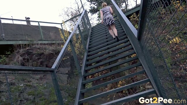 Delectable blonde babe in zebra print dress down the stairs