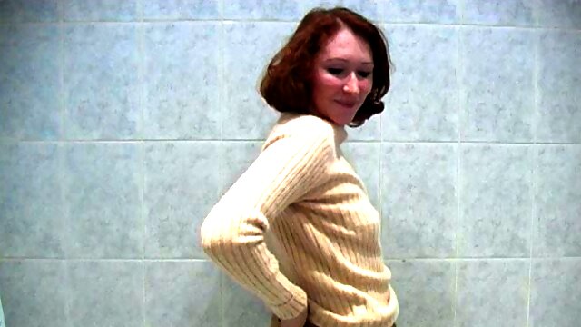 Redhead sexy Russian chick undresses in the bathroom and pisses like a boy