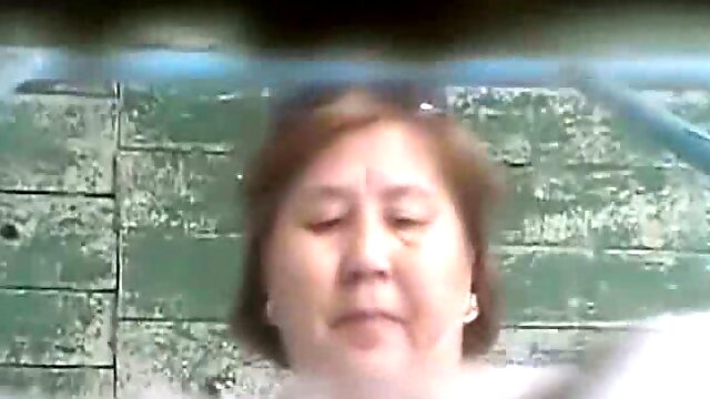 Mature Asian lady in the shabby toilet room filmed on hidden cam