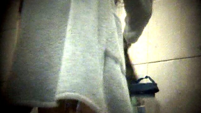 Amateur white woman dries up her body with towel in the locker room