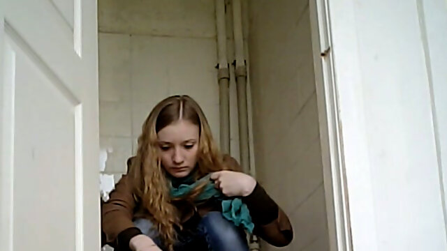 Young blondie pulls down her jeans and pisses in the toilet