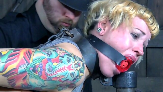 Tattooed short haired light haired bitch is belted and gagged