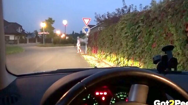 Slender leggy auburn chick is caught pissing near the road sign