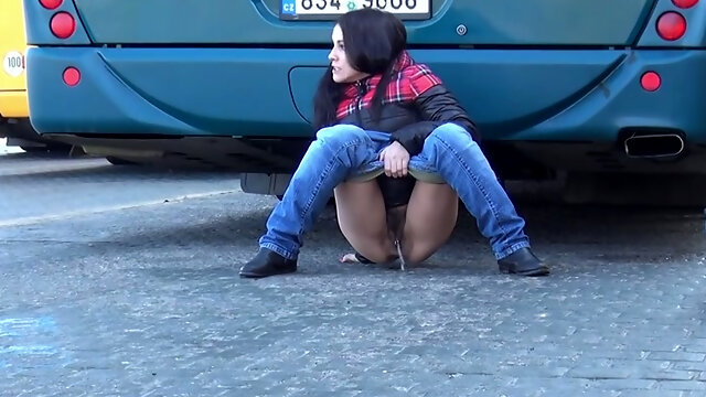 Dirty-minded brunette pulls down jeans to pee at the bus depot