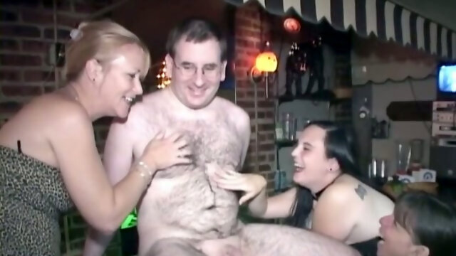Hairy dude lets three insatiable sluts suck his wang in a bar