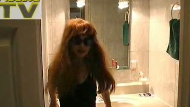 Russian redhead lady sits on the bathroom shelf and pees in the sink