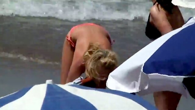 Spying on sexy blonde MILFs while they sunbathe on a beach