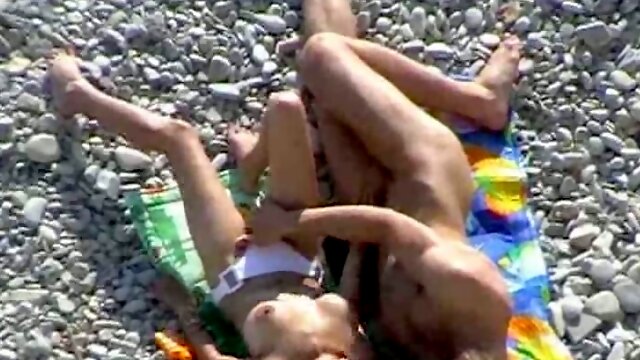 Torrid brunette MILF gives head to her boy on rocky beach