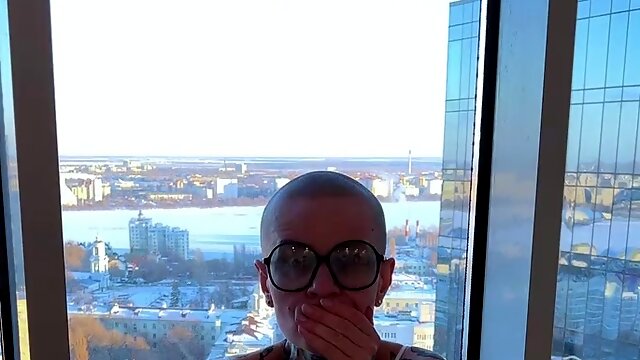 Busty bald alt bitch masturbates at the window with a pink vibrator!