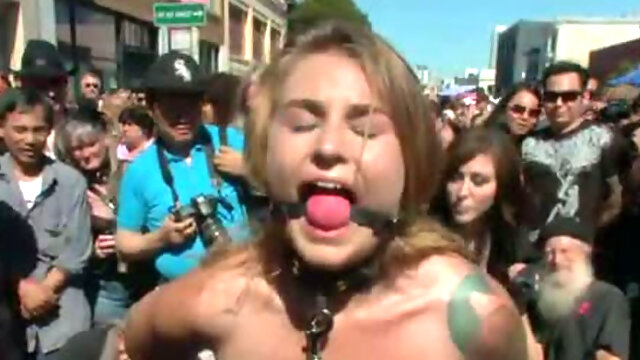 Crowd of people punishes one whorish chick in the street