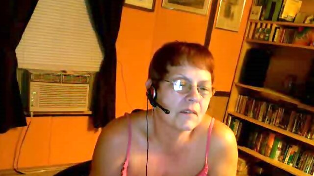 Redhead mature speaks with a young lover over the webcam