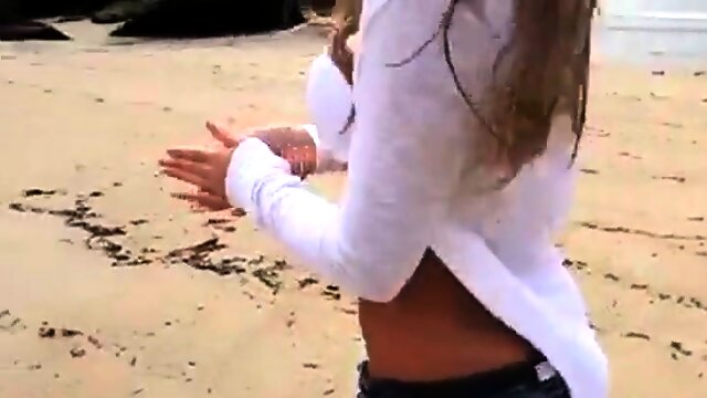 Dionne Daniels strips on the beach