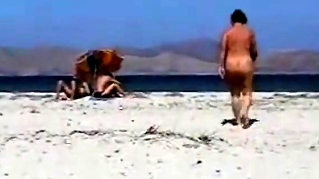 Mature masturbating naked on the beach