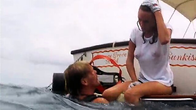 Jacqueline Bisset scuba diving in a white t-shirt that