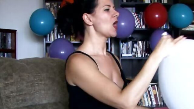 Brunette slut teasing while blowing balloons