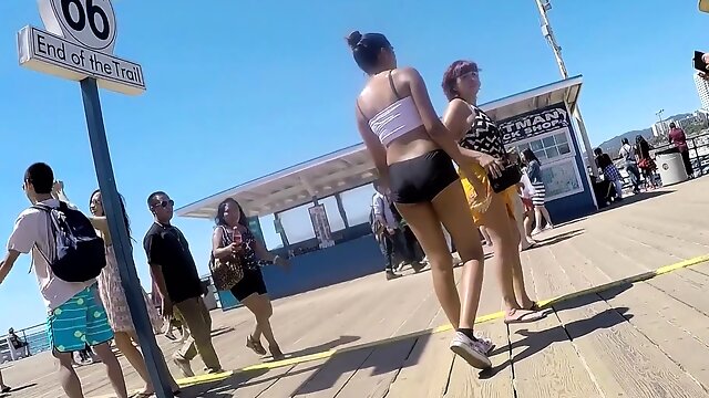 Slim brunette teen ass in tight shorts at the beach