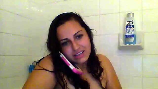 Chubby brunette in the bath shows her tits and shaved pussy