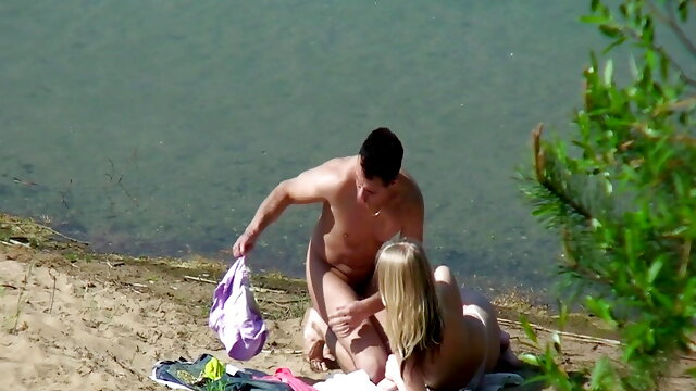 A couple of young nudists are spied on while having sex and