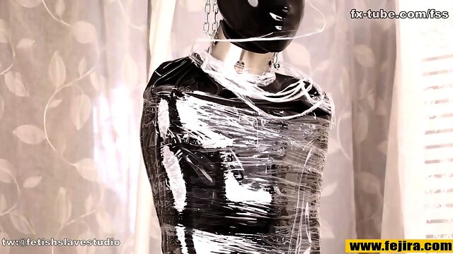 Fejira com Full body wrapped in tight latex clothing and plastic wrap