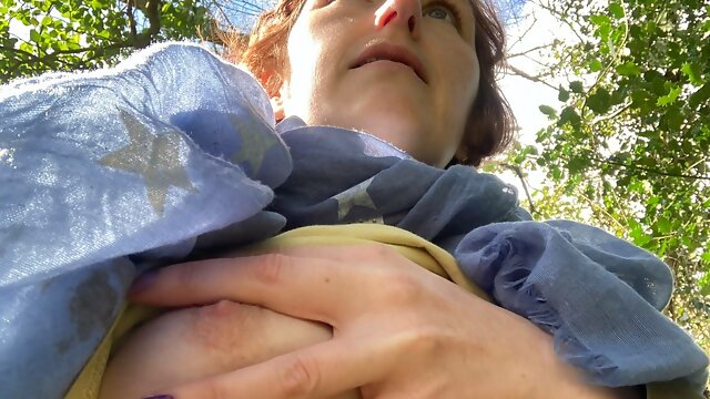Mommy nearly got caught by amblers as she plays with her awesome tits whilst walking along the river in the spring sun