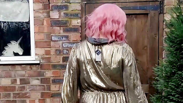 Sissy crossdresser outdoors in gold metallic shiny dress