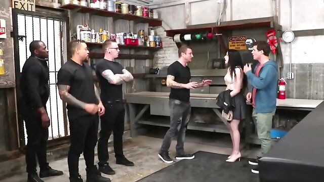 Slutty girl is fucked by a bunch of guys in a warehousde