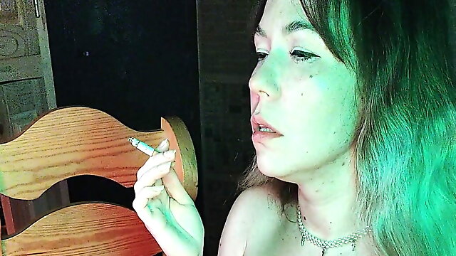 Mistress smokes a cigarette