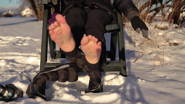 Winter Shoeplay Dangling Winter Boots Showing Soles And Wiggling Toes On Snow