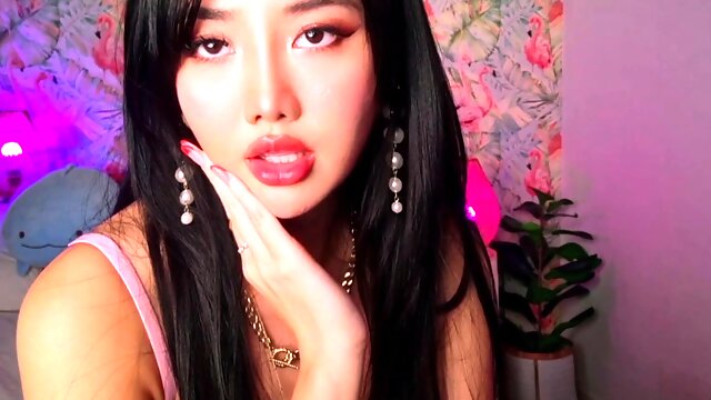 Asian babe sucking and jerking two hard dicks