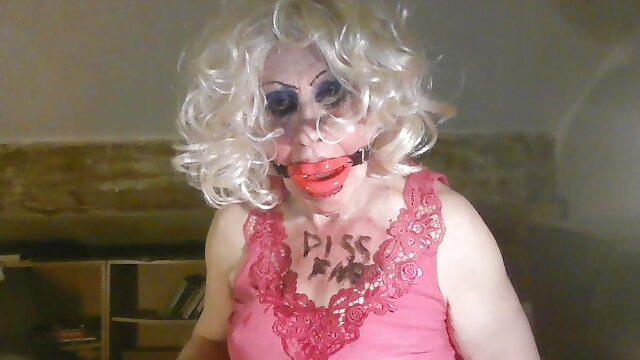 Sissy cd whore, Sarah, humiliates herself, by drinking own piss, while mouth gagged
