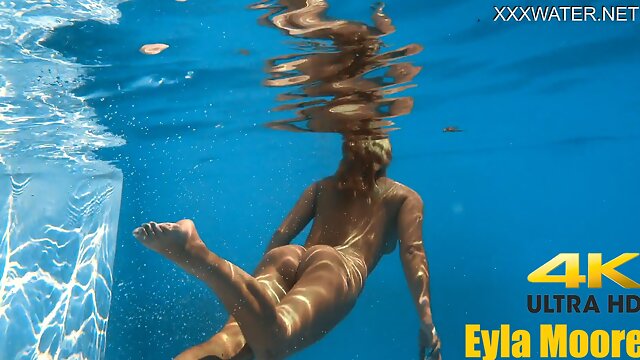 Eyla Moore, a famous model, glides elegantly through the water