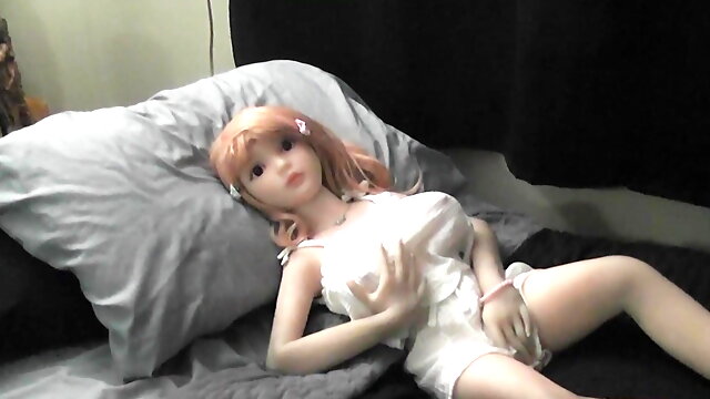 Camiile - Sex Doll poses in a sexy white halter top outfit showing off her boobs