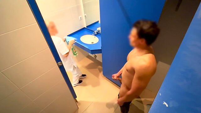 I surprise the cleaning lady at the gym giving me a handjob in the bathroom and she helps me finish cumming with a blowjob