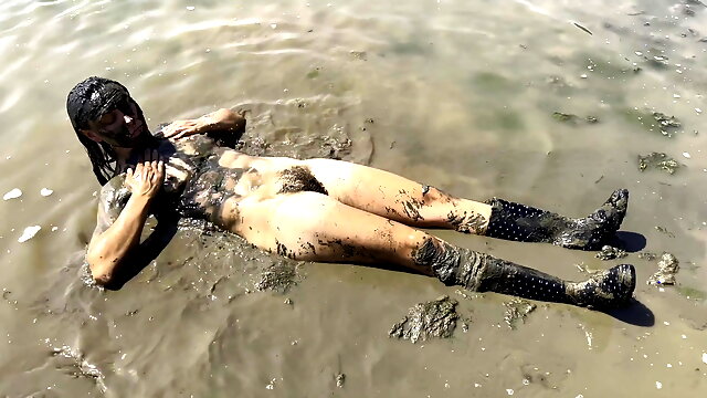 Estuary mud girl playing in the nude