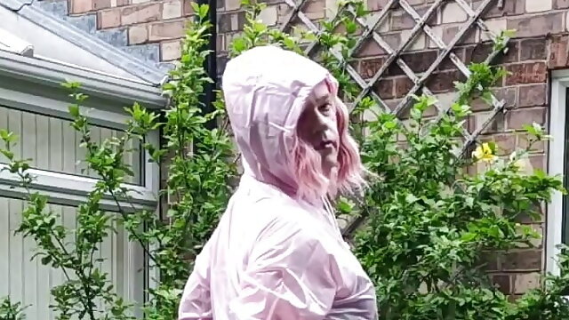 Tranny slut in pink PVC boiler suit outdoors