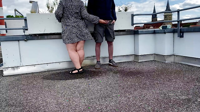 Gorgeous pissing mother-in-law helps son-in-law piss on the top of the parking lot