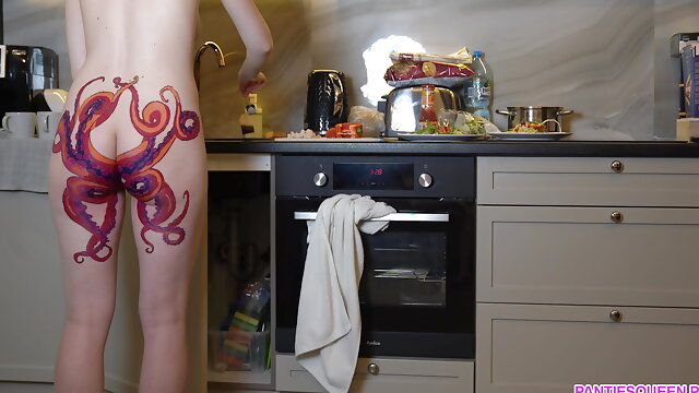 Naked housewife with octopus tattoo on butt cooks dinner on kitchen and ignores you