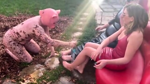 Foot slave being taught servitude and obedience outdoors