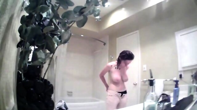 Hidden cam captures big boobed stepsis naked in the bathroom