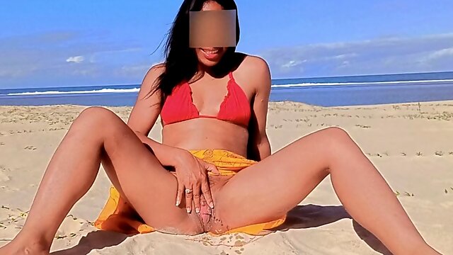She pisses on a public beach in front of the camera.compilation