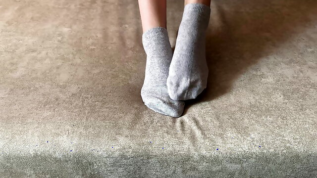 Gloria Gimson strokes her sexy feet in gray socks